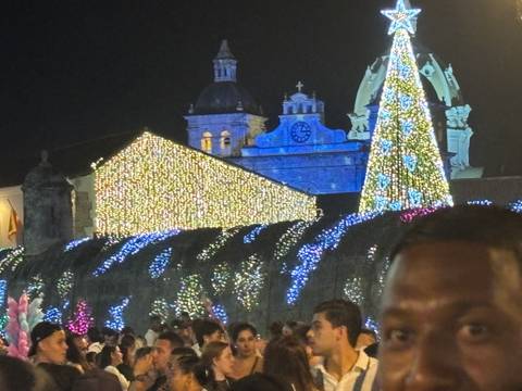 Night scene with buildings and Christmas lights.
