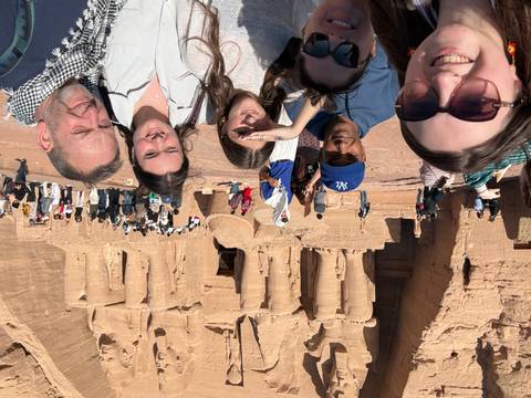       A group of people in front of massive ancient structures during the day.
  