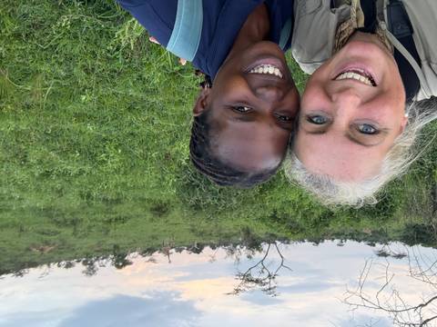       Selfie of two people with wildlife in the background
  