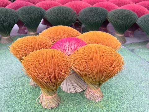       Bundles of colorful incense sticks.
  