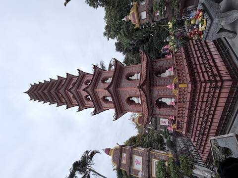       Tall ornate pagoda with statues at each level.
  