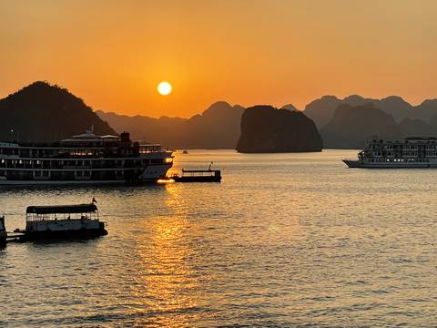 Sunset over water with cruise ships.