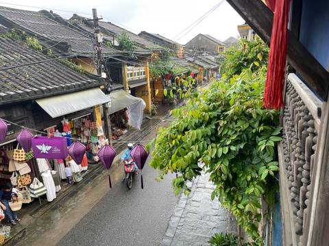       Street view from above with various shops and people.
  