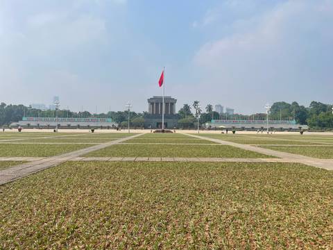       Mausoleum with large square and flag in front.
  