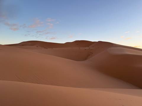 Sand dunes under a clear sky.