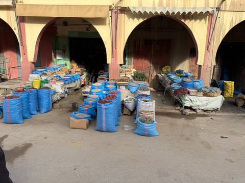Market with sacks and boxes of goods.