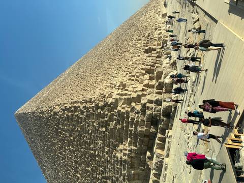 Tourists at the base of the Great Pyramid of Giza.