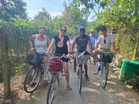 Group of tourists enjoying a bicycle ride through lush greenery.