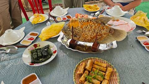 Various Vietnamese dishes set on a table for a group meal.