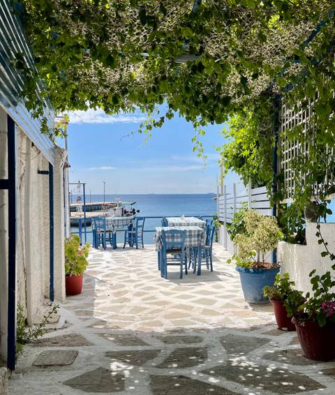       Coastal cafe table setup with a sea view.
  