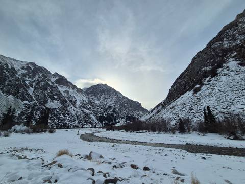 Snowy mountain landscape with a winding river.