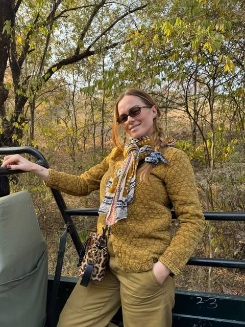       Woman posing for a picture on a safari ride.
  