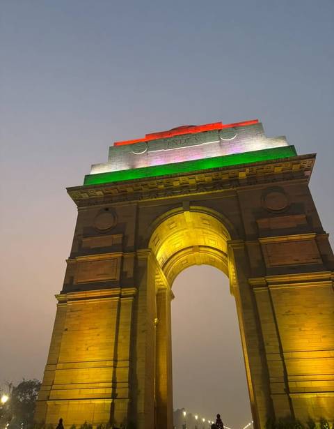       India Gate illuminated with tricolor lights.
  
