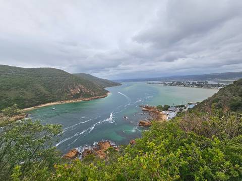       Aerial view of a lagoon and surrounding hills.
  