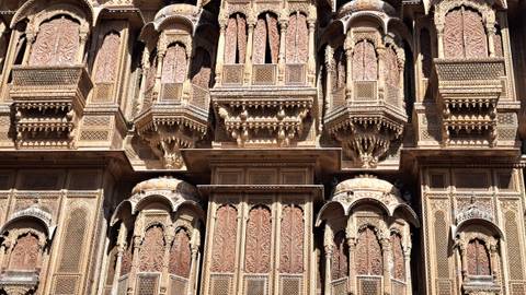       Detailed view of intricately carved facades on a historic building.
  
