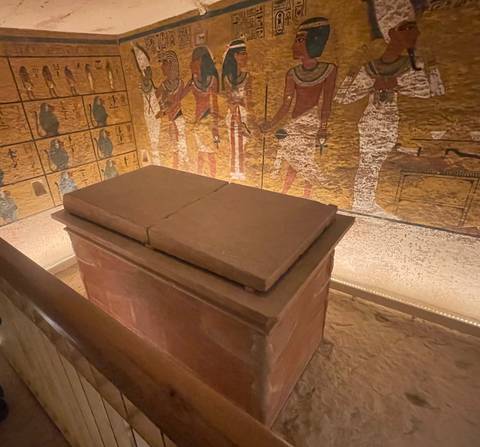 Interior of an ancient tomb with hieroglyphic murals.