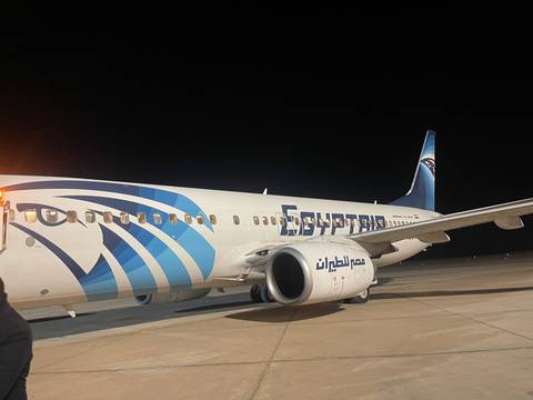 An airplane on the tarmac at night.