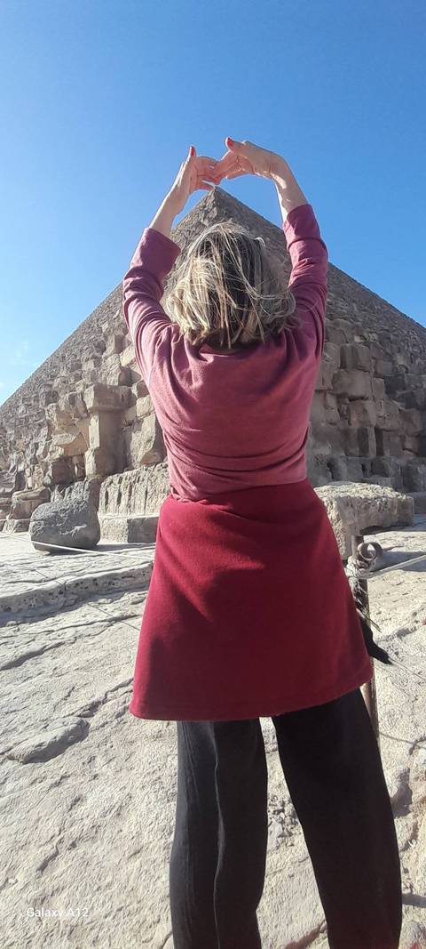 Close-up of a person with ancient ruins in the background.