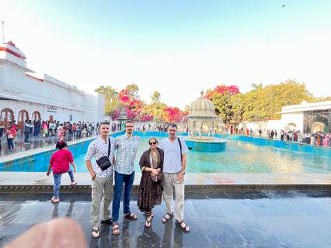 Family posing in front of a historic structure with fountains.