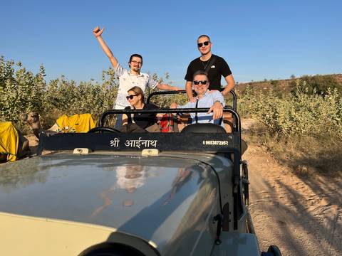 Group in an open-top vehicle participating in a tour.
