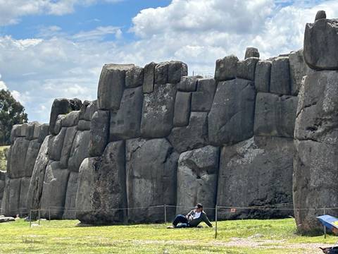      Massive stone walls with a person for scale.
  