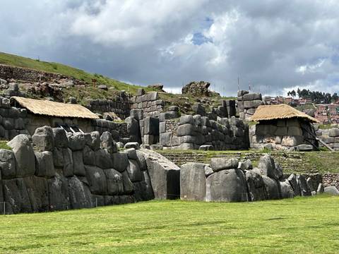      Ancient stone walls and thatched roof structures.
  
