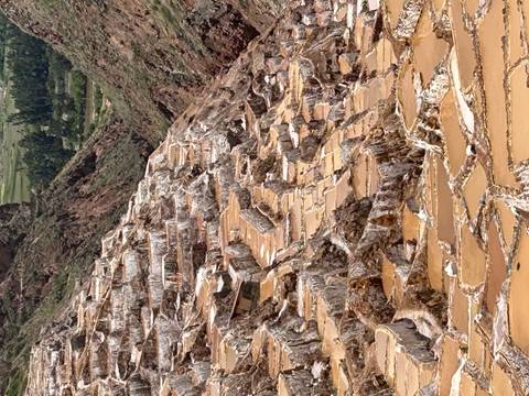       Terraced salt ponds cascading down a mountain valley.
  