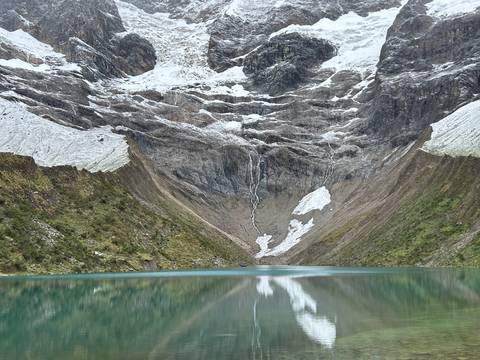       Mountain valley with glacial lake and snowcapped peaks.
  