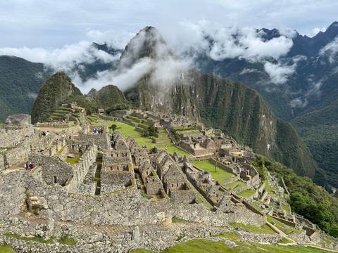Panoramic view of Machu Picchu amidst misty mountains.