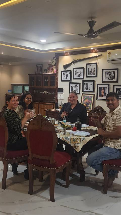 Group of people enjoying a meal in a decorated room.