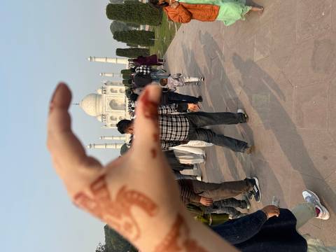 A person pretending to hold the Taj Mahal in their hand.
