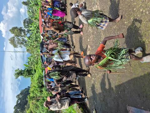 Children in traditional dress participating in a cultural dance.