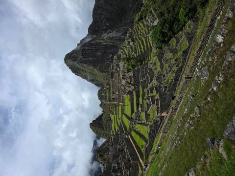 Iconic mountain overlooking Machu Picchu ruins.