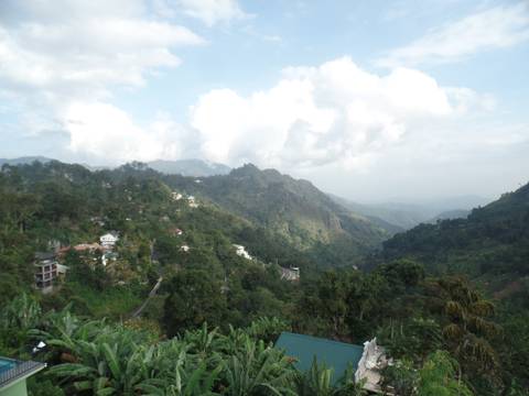 View of mountainous landscape with scattered houses.