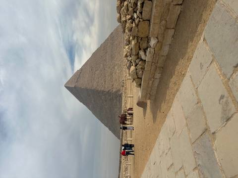Great Pyramid of Giza on a cloudy day with visitors