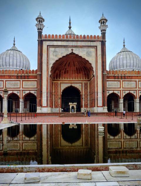 Majestic mosque reflected in water.