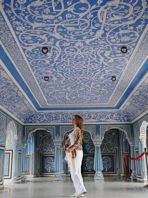 Elegant room with intricate blue patterns on the walls.