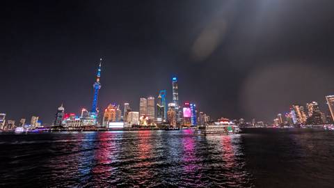 Shanghai skyline at night with lit buildings.