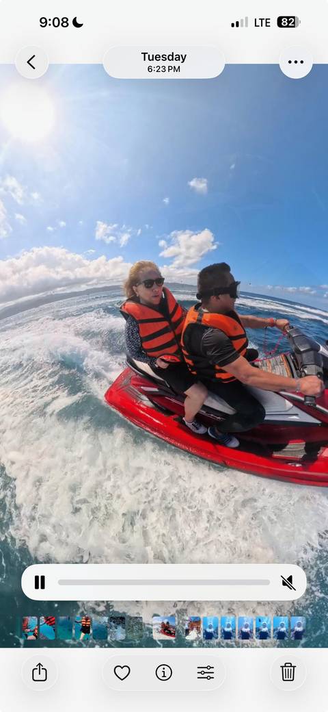 People enjoying a jet ski ride on the ocean wearing safety gear.