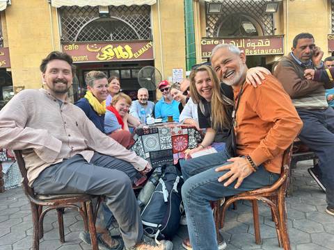 A group of people sitting at a cafe table.