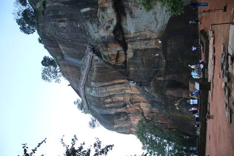 Rock fortress with a staircase and people climbing.