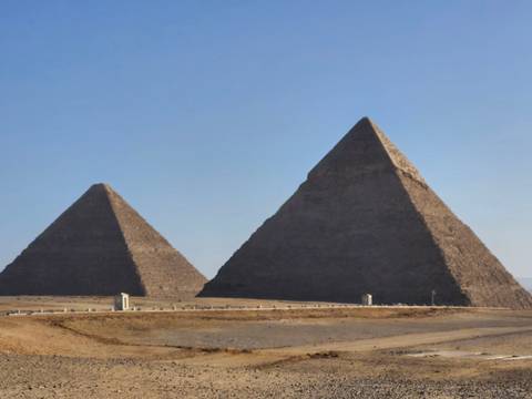 The Pyramids of Giza with a clear blue sky.