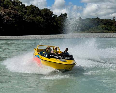 People enjoying a jet boat ride on a river.