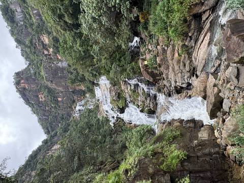       A cascading waterfall flowing down a rocky cliffside.
  