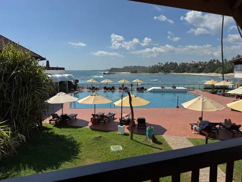 Resort swimming pool area overlooking the ocean.