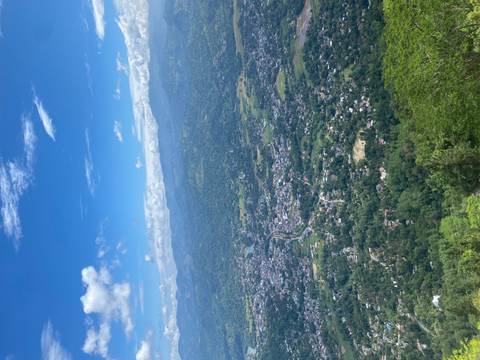       Aerial view of a city with mountains in the distance.
  