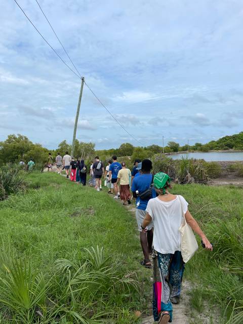       Group walking along a trail in a natural area.
  