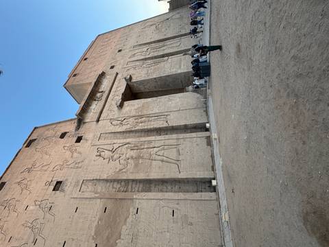       Massive stone walls with hieroglyphs and Egyptian figures.
  