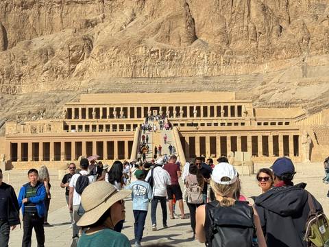       Temple of Hatshepsut with tourists entering the site.
  