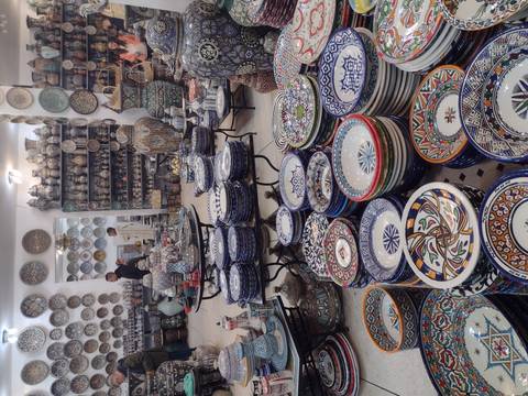 Shop with colorful pottery displayed.